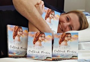 Cathryn cuddling copies of Elsa's Stand